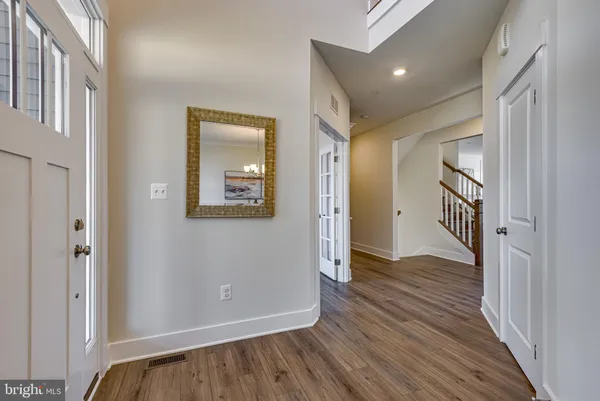 a view of hallway with wooden floor