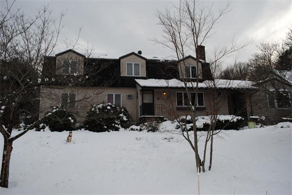 234 West Acton Road Stow, MA 01775 - Photo 3 of 7 a view of a house with a yard covered in snow