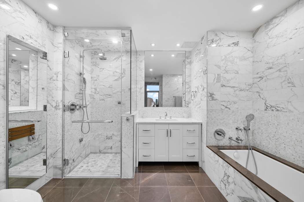 35 West 15th Street, Unit 13B Manhattan, NY 10011 - Photo 3 of 10 a spacious bathroom with a granite countertop sink mirror and shower