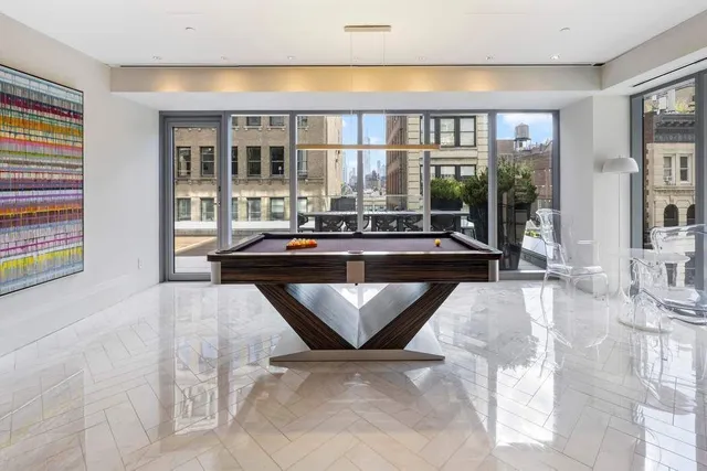 a living room with furniture and large window