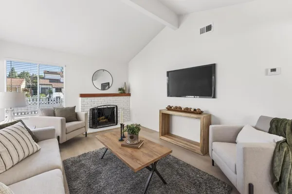 a living room with furniture and a fireplace