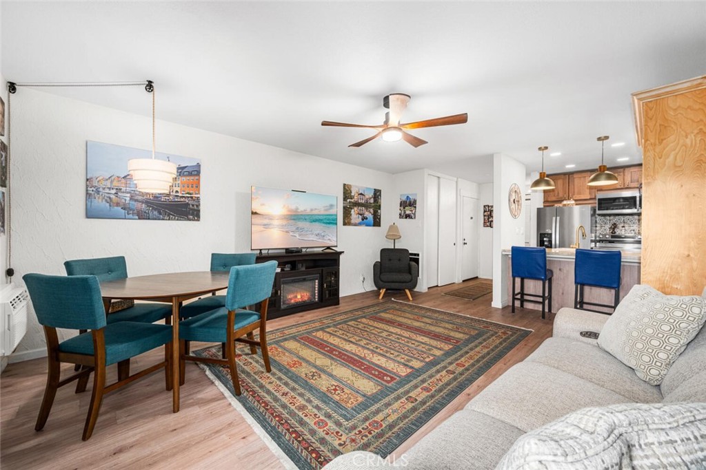 7890 East Spring Street, Unit 4W Long Beach, CA 90815 - Photo 11 of 36 a living room with furniture kitchen view and a table