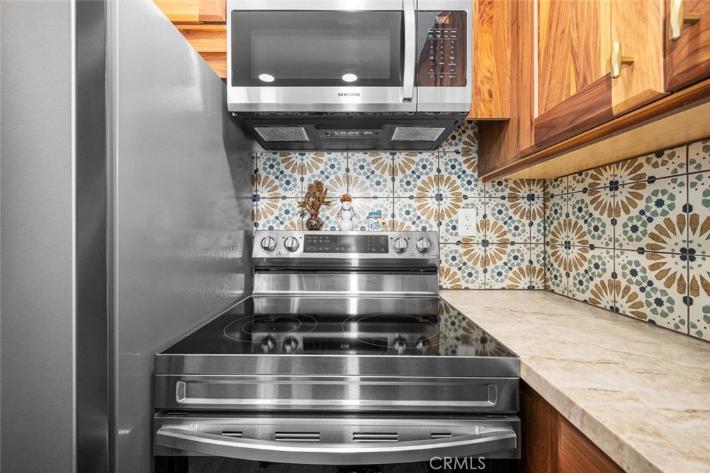 7890 East Spring Street, Unit 4W Long Beach, CA 90815 - Photo 15 of 36 a stove top oven sitting inside of a kitchen