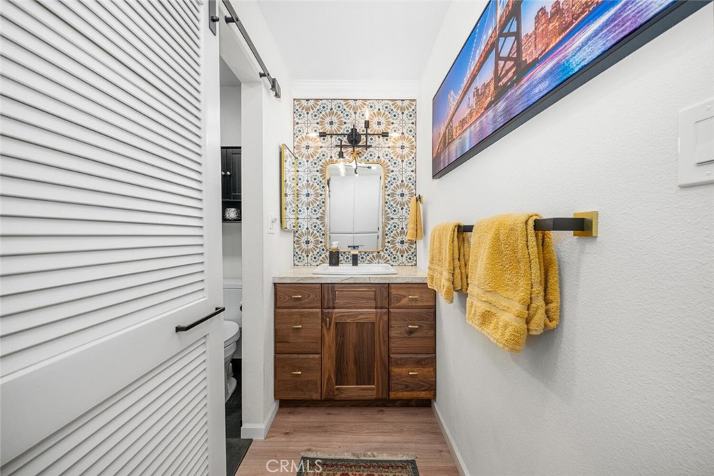 7890 East Spring Street, Unit 4W Long Beach, CA 90815 - Photo 21 of 36 a bathroom with a sink and mirror