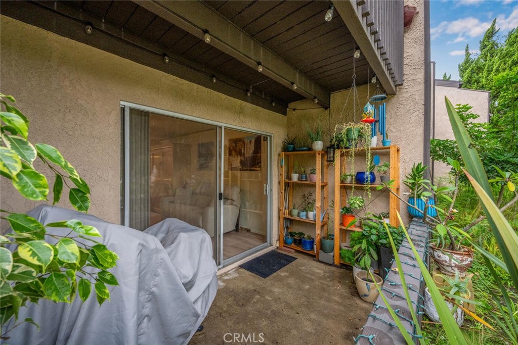 7890 East Spring Street, Unit 4W Long Beach, CA 90815 - Photo 25 of 36 a view of a porch with chairs and potted plants