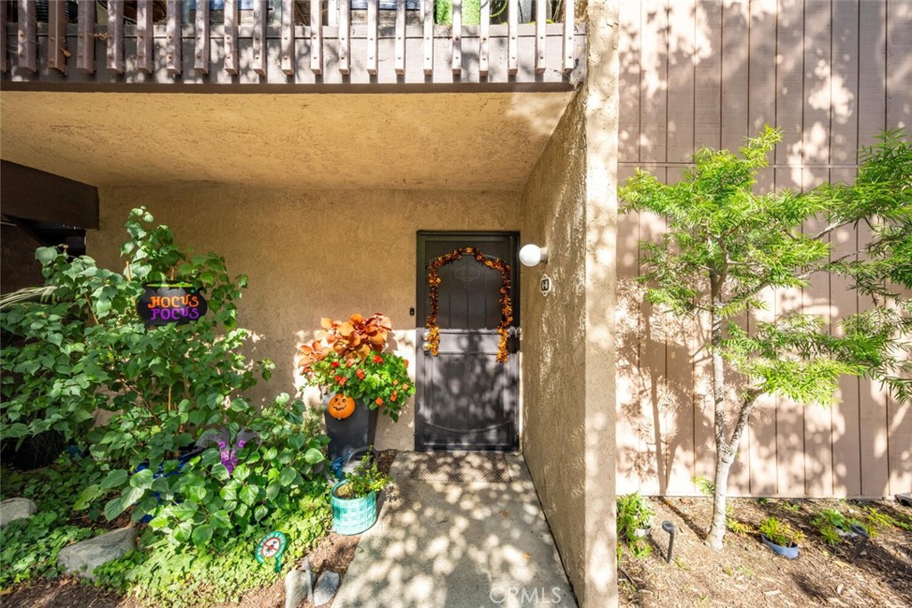 7890 East Spring Street, Unit 4W Long Beach, CA 90815 - Photo 28 of 36 a vase of flowers sitting in front of a door