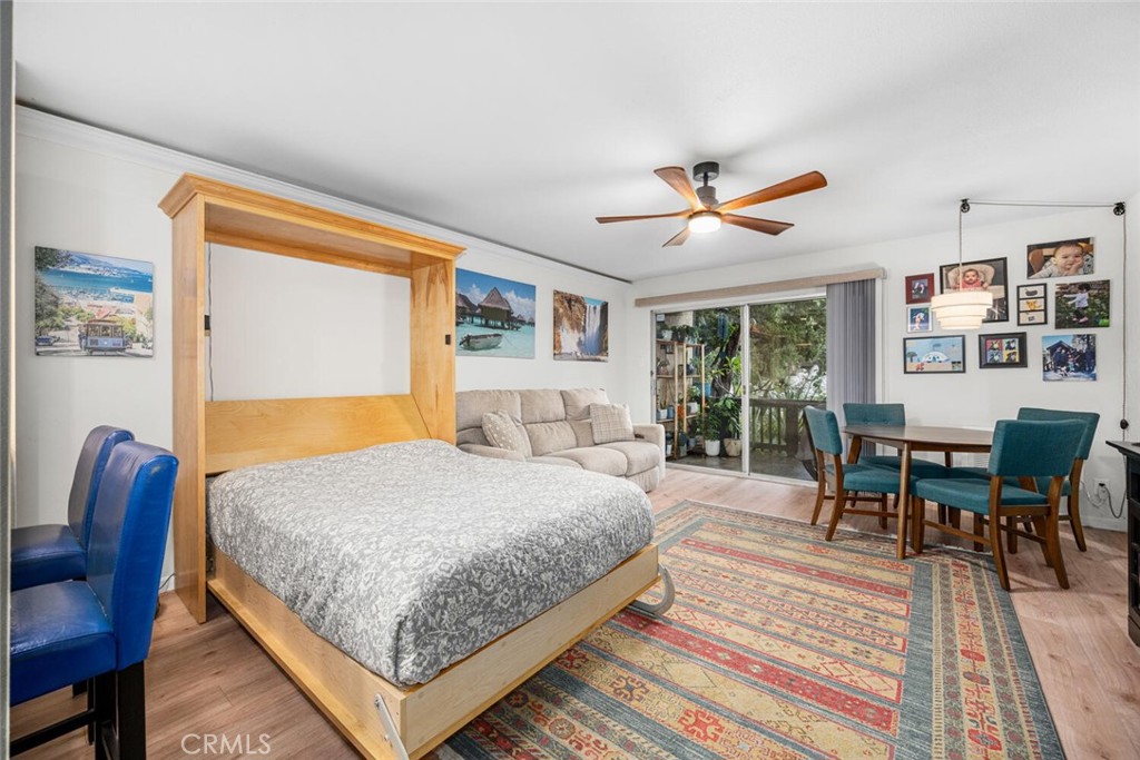 7890 East Spring Street, Unit 4W Long Beach, CA 90815 - Photo 6 of 36 a bedroom with a bed a table and chair