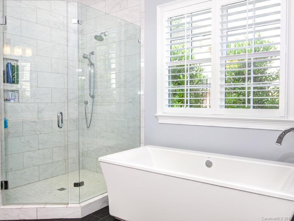 6237 Sharon Acres Road Charlotte, NC 28210 - Photo 21 of 48 a bathroom with a shower and a bathtub