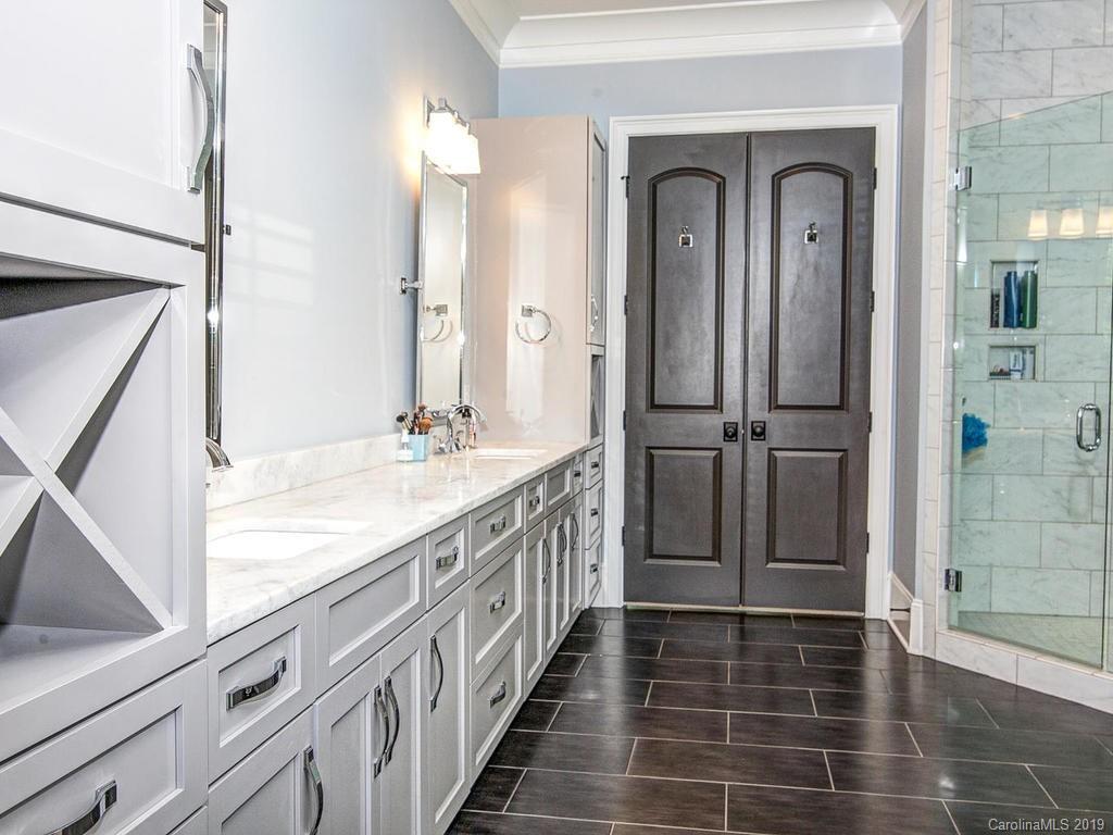 6237 Sharon Acres Road Charlotte, NC 28210 - Photo 22 of 48 a bathroom with double vanity and a mirror