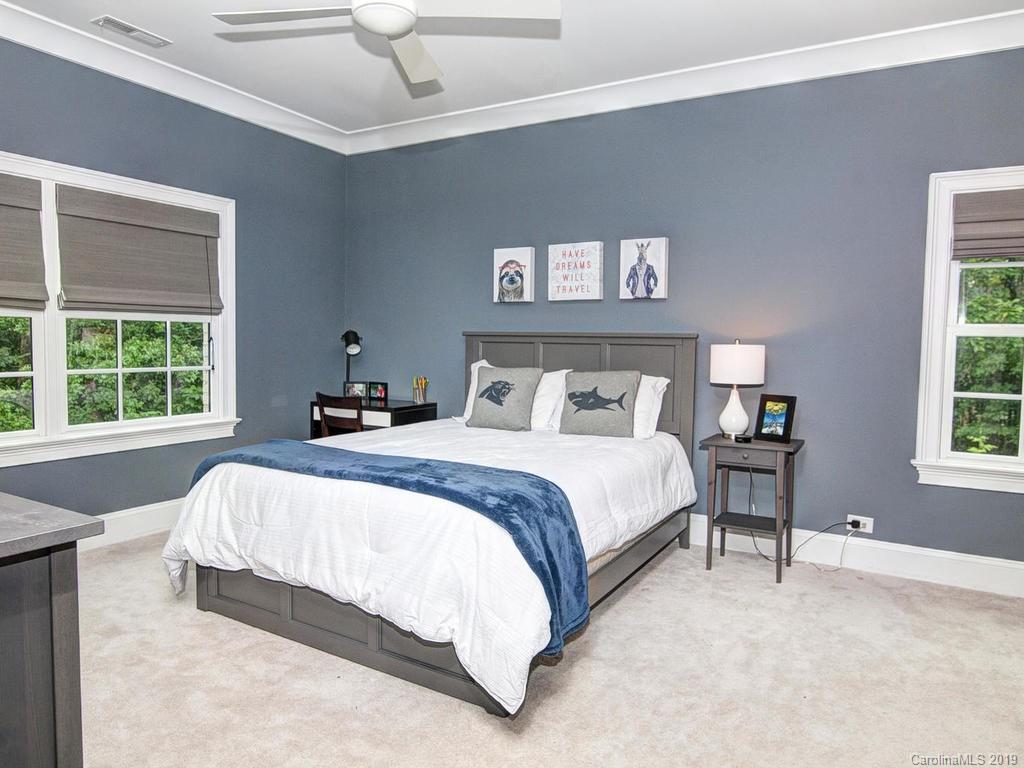6237 Sharon Acres Road Charlotte, NC 28210 - Photo 27 of 48 a bedroom with a bed and a window