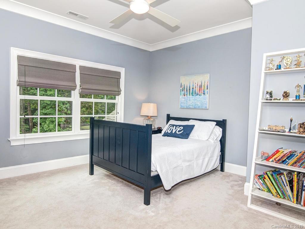 6237 Sharon Acres Road Charlotte, NC 28210 - Photo 30 of 48 a living room with a bed and a book shelf