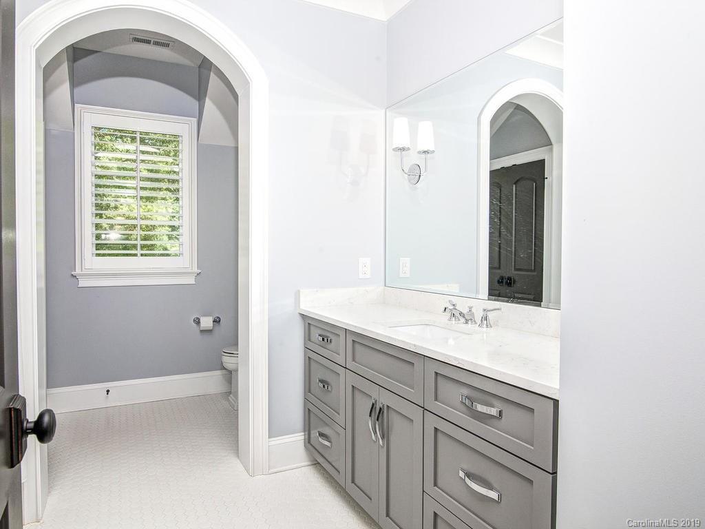 6237 Sharon Acres Road Charlotte, NC 28210 - Photo 31 of 48 a bathroom with a sink and a mirror