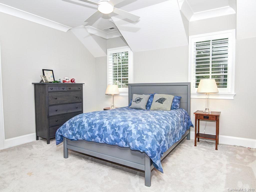 6237 Sharon Acres Road Charlotte, NC 28210 - Photo 33 of 48 a bedroom with a bed and a dresser