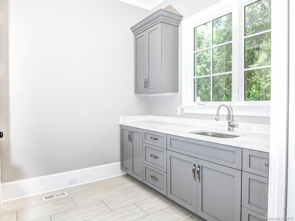 6237 Sharon Acres Road Charlotte, NC 28210 - Photo 37 of 48 a bathroom with a granite countertop sink and mirror