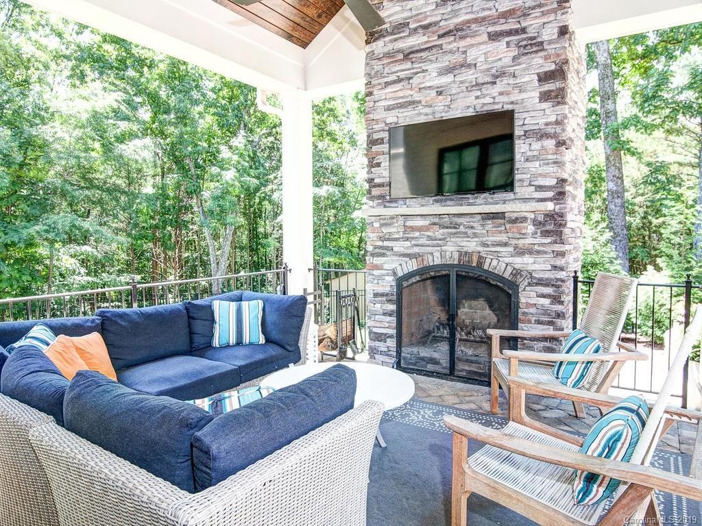 6237 Sharon Acres Road Charlotte, NC 28210 - Photo 40 of 48 a view of a patio with couches chairs and a fireplace