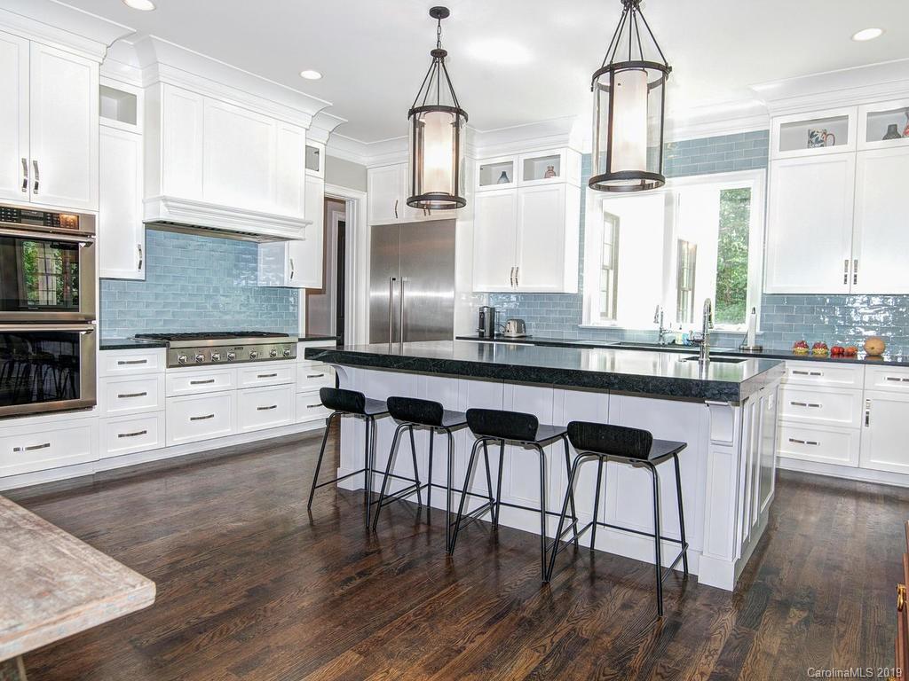 6237 Sharon Acres Road Charlotte, NC 28210 - Photo 7 of 48 a kitchen with stainless steel appliances kitchen island granite countertop a stove a sink and a wooden cabinets