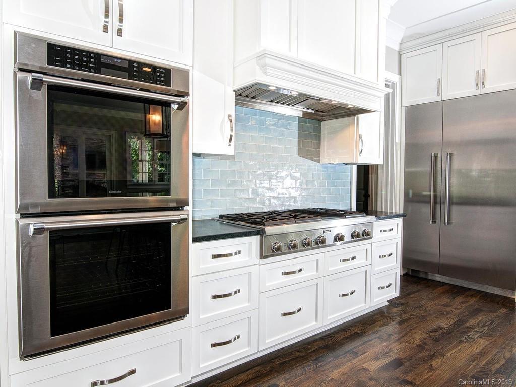 6237 Sharon Acres Road Charlotte, NC 28210 - Photo 8 of 48 a kitchen with stainless steel appliances granite countertop a stove microwave and refrigerator