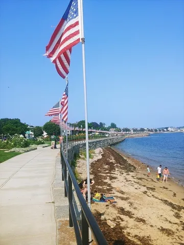 a street view with sitting space and lake view