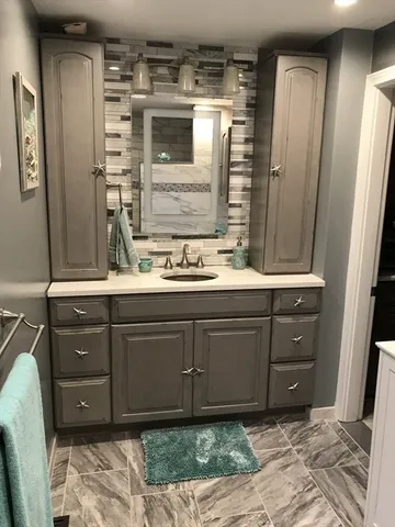 a bathroom with a sink and a mirror
