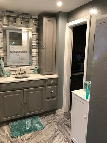 a bathroom with a sink a vanity and a mirror