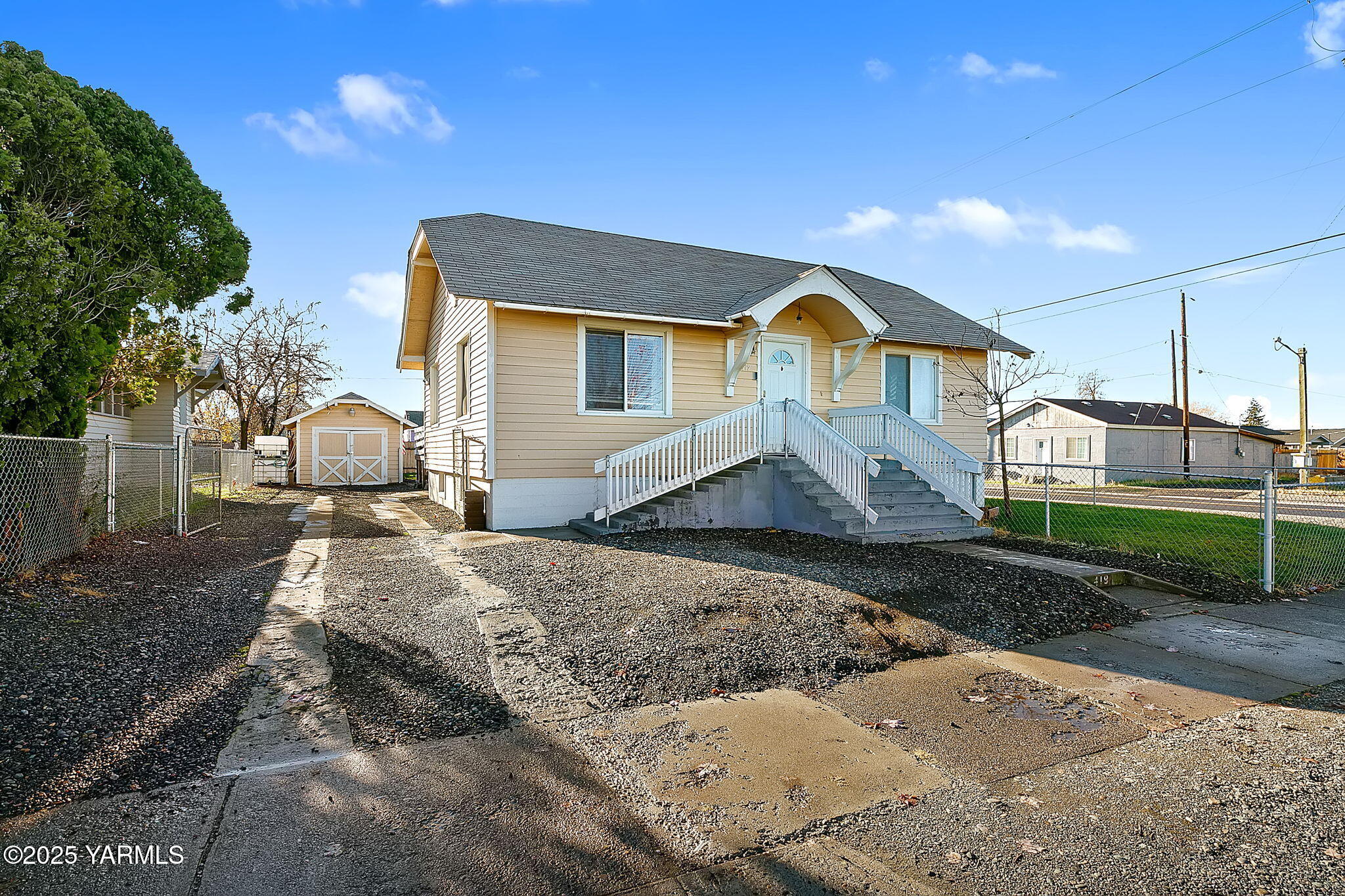 419 West 3rd Street Wapato, WA 98951 - Photo 3 of 19 a front view of a house with garden