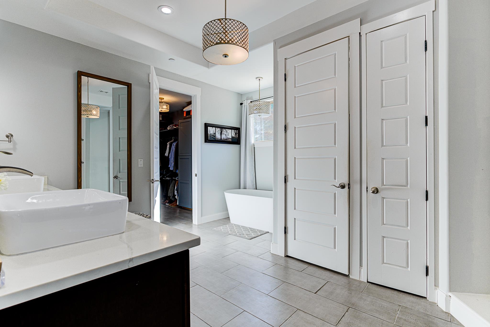 370 Wright Road Piperton, TN 38017 - Photo 13 of 31 Bathroom featuring vanity, shower with separate bathtub, and tile patterned flooring