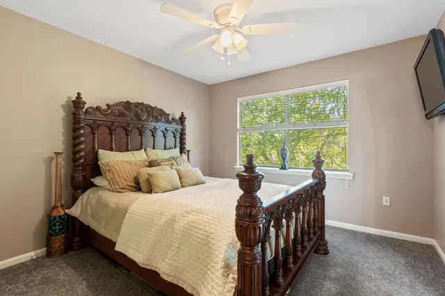 a bedroom with a bed and a chandelier