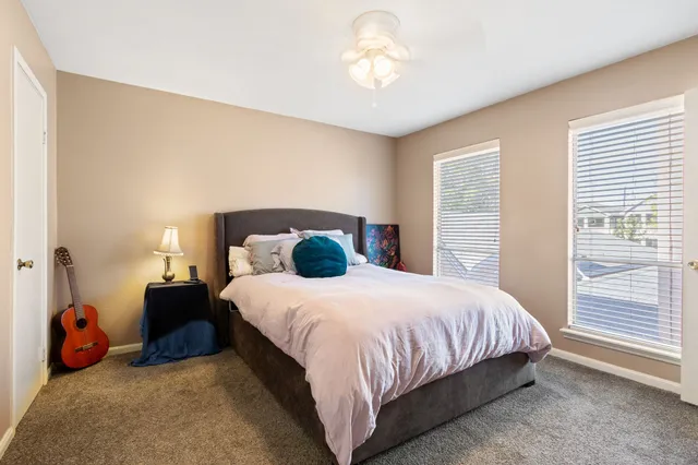 a bedroom with a bed and a chandelier