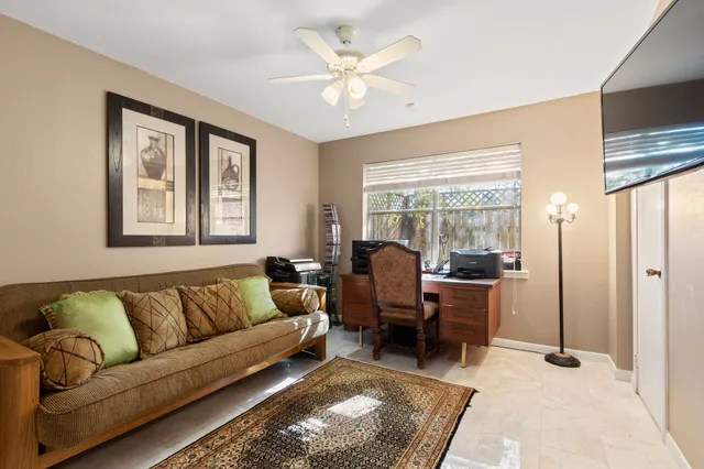 a living room with furniture and large windows