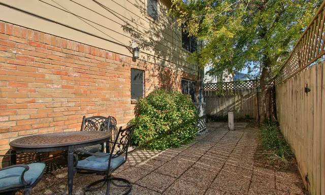 a backyard of a house with table and chairs