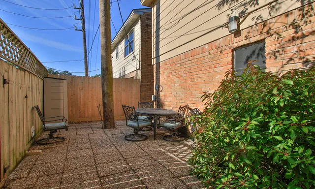 a backyard of a house with outdoor seating