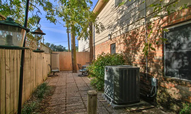 a view of a pathway of a house with backyard and trees