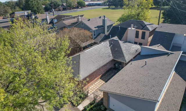 aerial view of a house with outdoor space and seating area