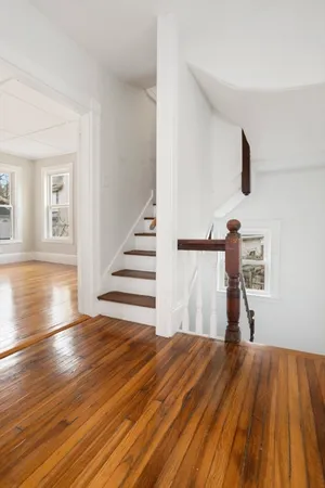 a view of a room with wooden floor and stairs