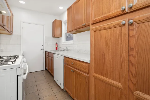 a kitchen with a sink cabinets and appliances