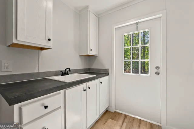 a kitchen that has a sink and a stove