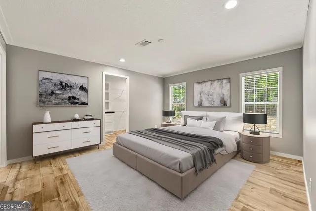 a spacious bedroom with a large bed and a window