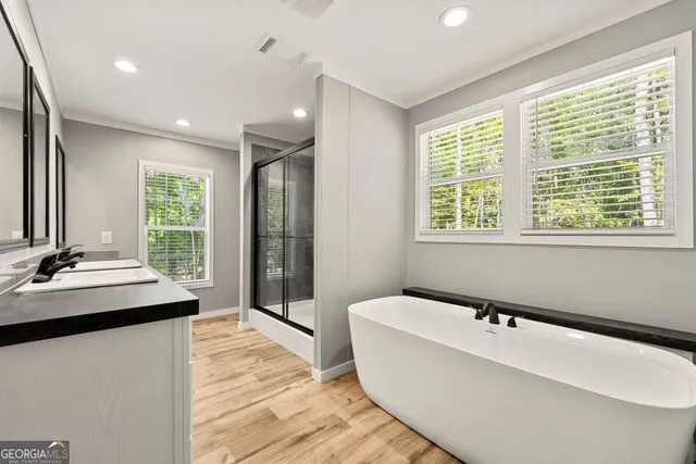 a bathroom with a tub sink and mirror