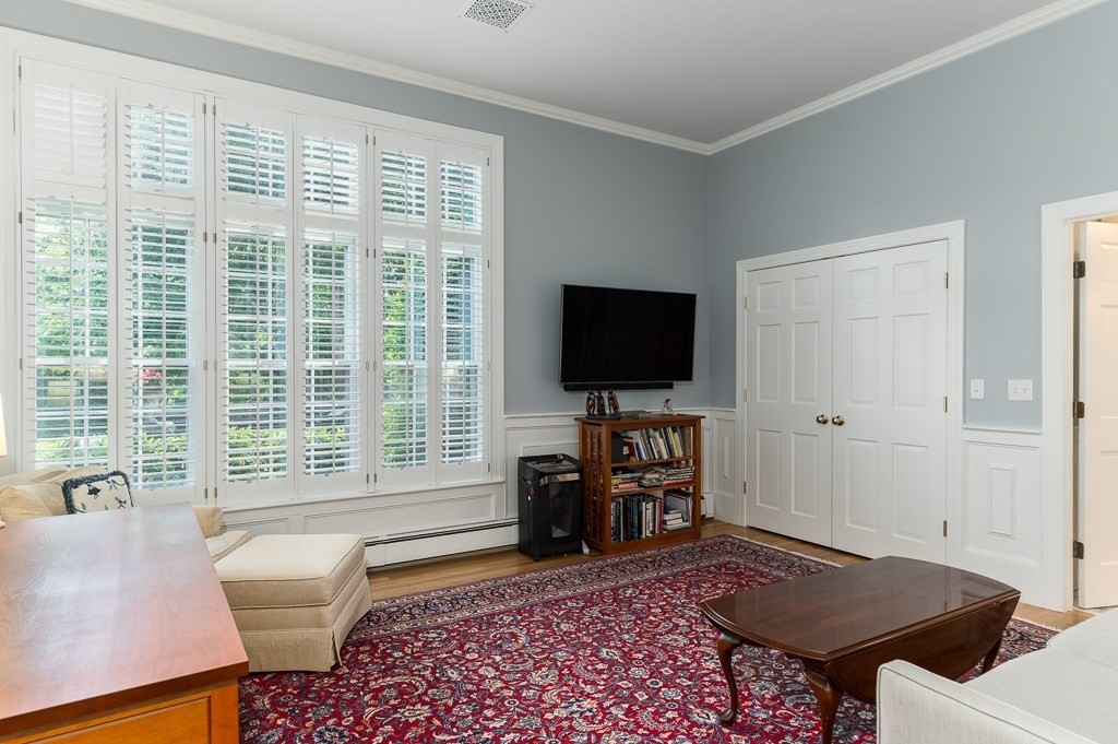 11 Thissell Street, Unit 3 Beverly, MA 01915 - Photo 13 of 31 a living room with furniture and a flat screen tv