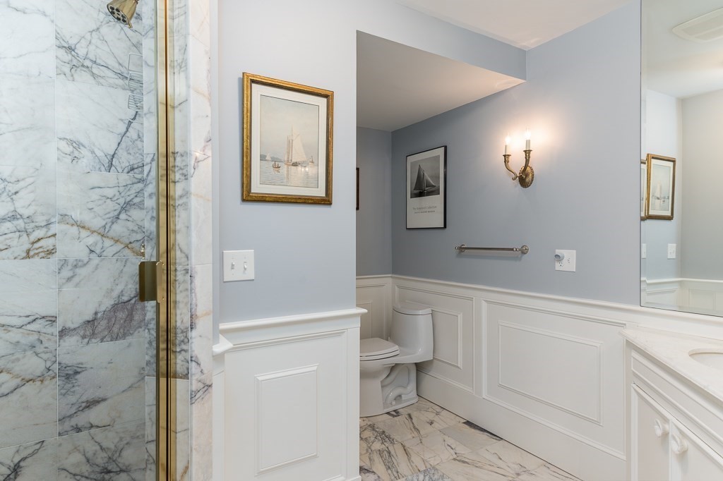 11 Thissell Street, Unit 3 Beverly, MA 01915 - Photo 14 of 31 a bathroom with a toilet a sink and mirror