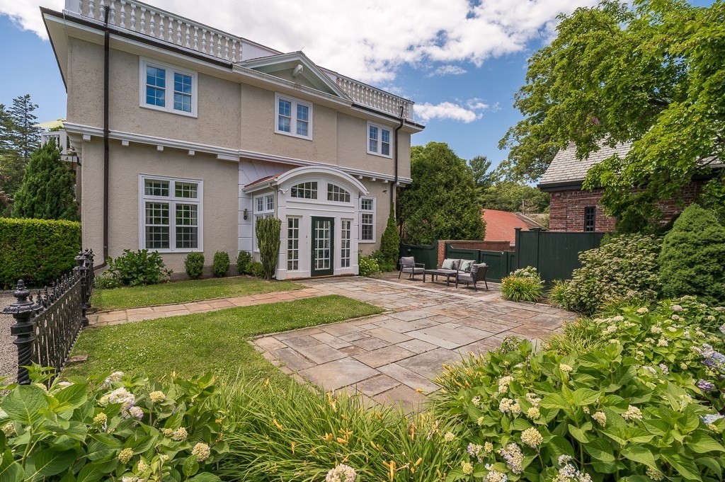 11 Thissell Street, Unit 3 Beverly, MA 01915 - Photo 2 of 31 a front view of a house with a yard