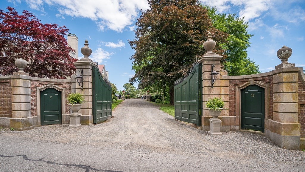 11 Thissell Street, Unit 3 Beverly, MA 01915 - Photo 31 of 31 a front view of a house with a yard and garage