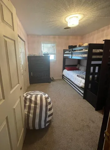 a bedroom with furniture and natural light