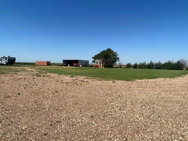 a view of a field with an trees