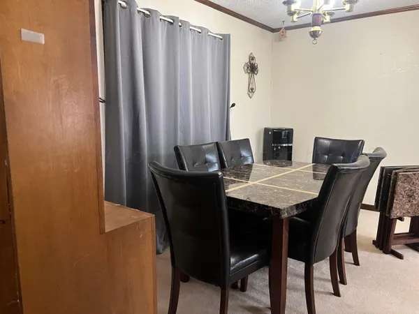 a view of a dining room with furniture and window