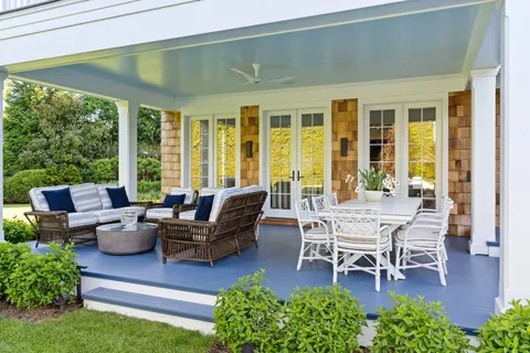 a building outdoor space with patio furniture and potted plants