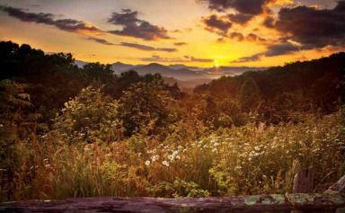 a view of mountain with sunset