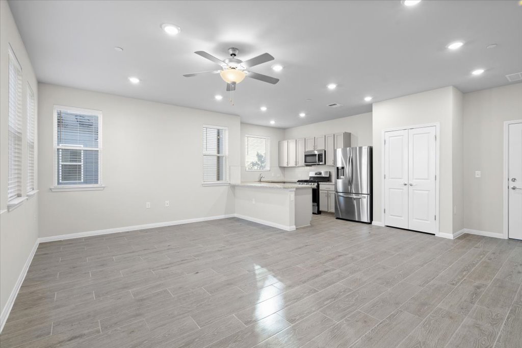 9015 Cattle Baron Path, Unit 705 Austin, TX 78747 - Photo 7 of 35 a view of a kitchen with a sink cabinets and window