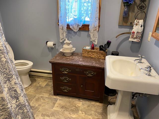 1395 Colonial Road Blue Ridge, VA 24064 - Photo 4 of 7 a bathroom with a granite countertop sink a toilet and a mirror
