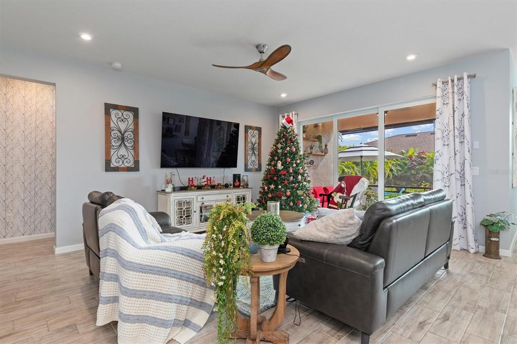 11819 Sistine Lane Venice, FL 34293 - Photo 12 of 90 a living room with furniture and a flat screen tv